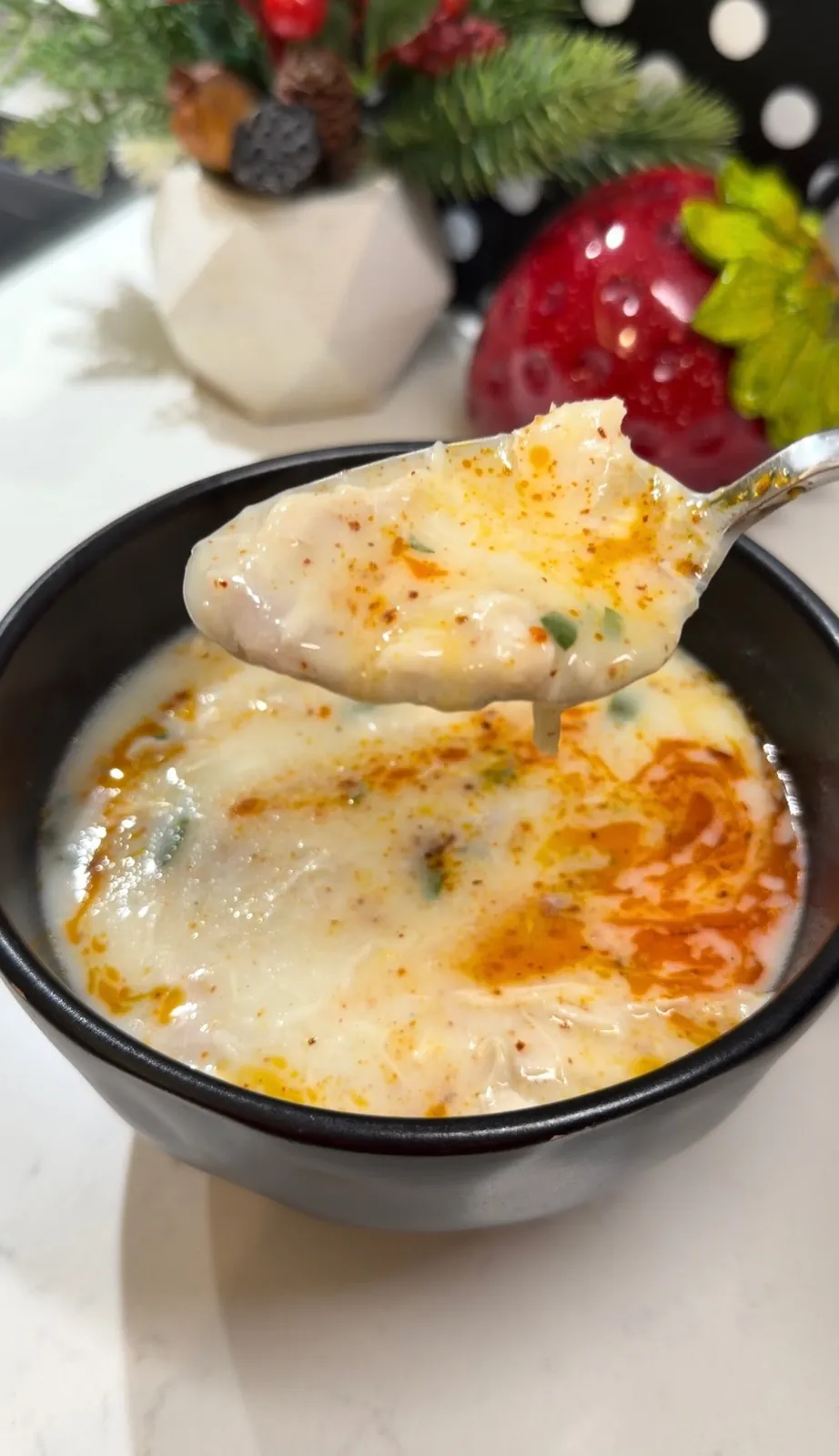 Creamy Turkish yogurt chicken soup with parsley ready to serve