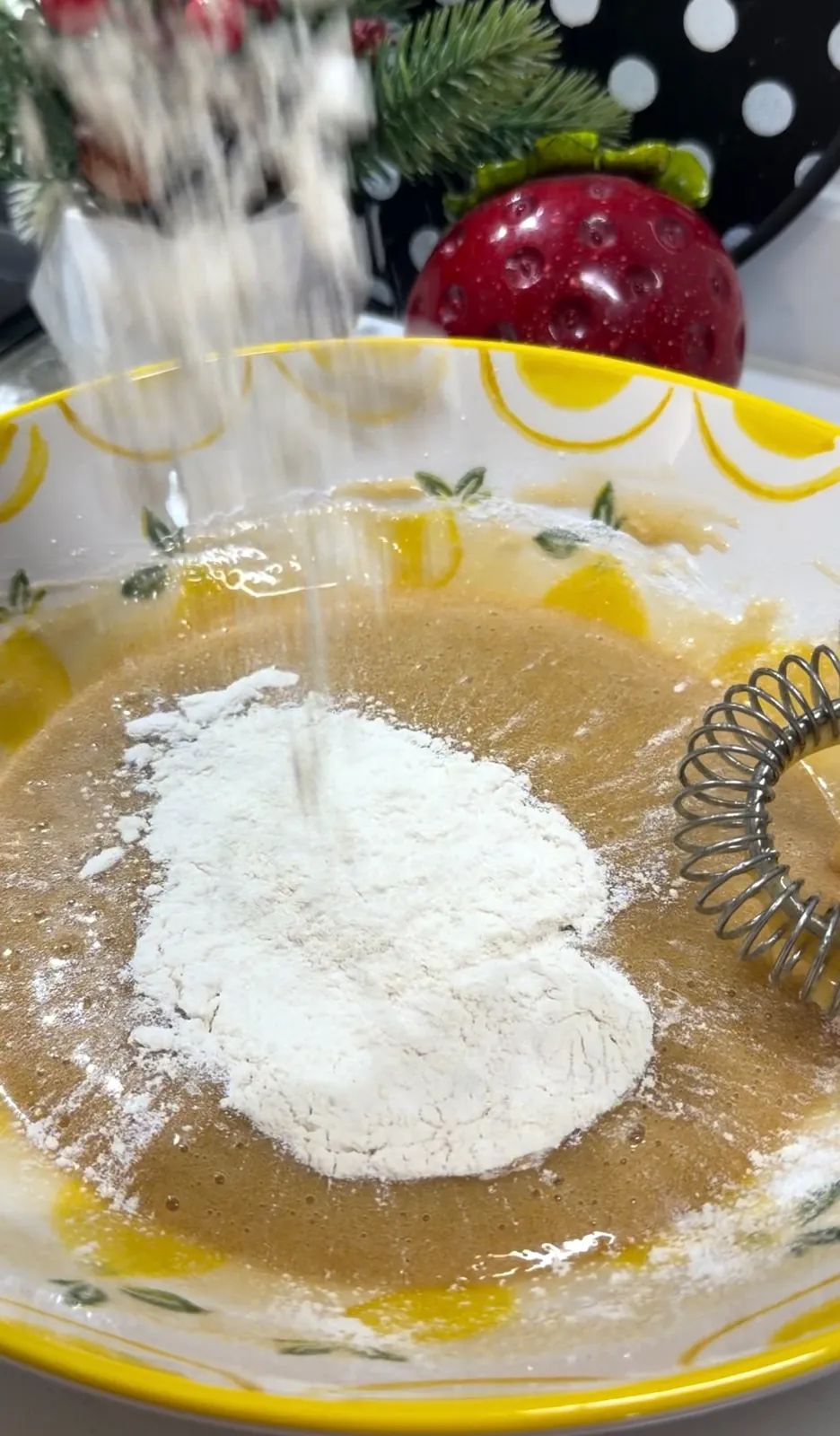 Flour being added while preparing chocolate chip cookie dough